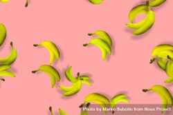 Scattered yellow bananas on a pink background 4AvQEb
