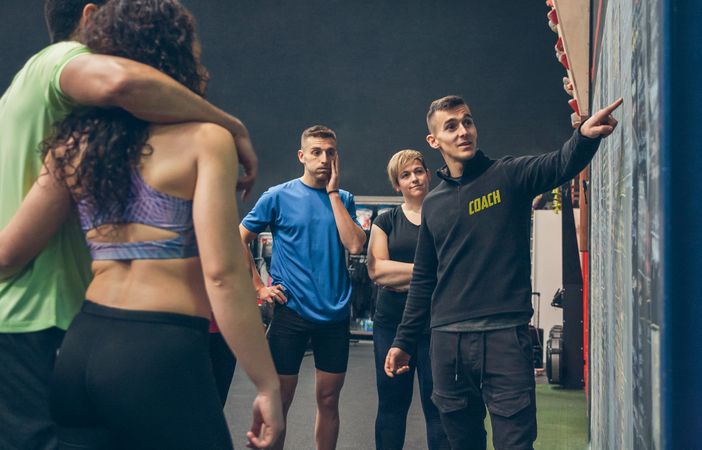 Coach explaining to athletes in the gym