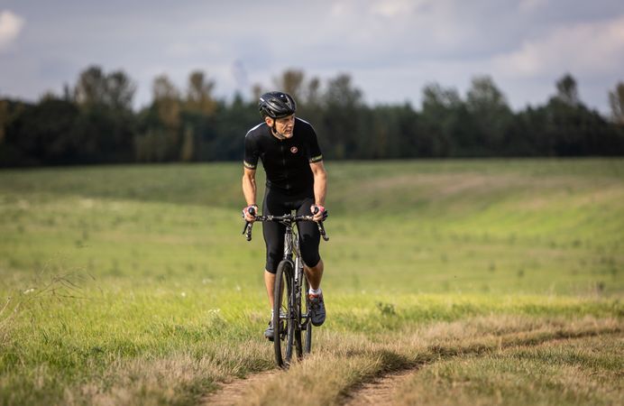 Man riding bicycle in field