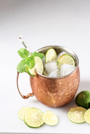 Cold Moscow Mules Cocktail with Ginger Beer, Vodka, Lime, and Mint Leaf.