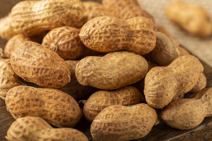 Dry peanut on the wooden background.
