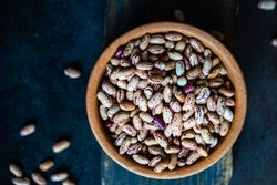 Pinto beans in bowl on wooden serving board