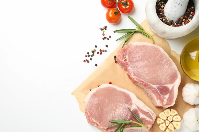 Composition with raw meat and ingredients on light background, top view