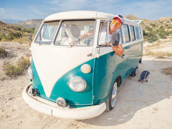 Man looking out of front window of car to see road