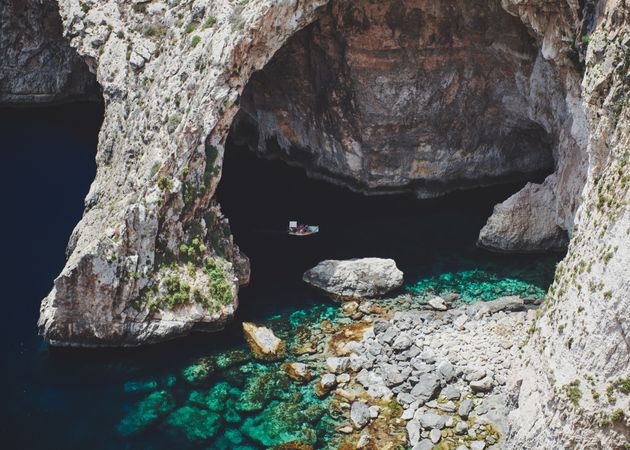 Small boat floating in cave along the Mediterranean coast