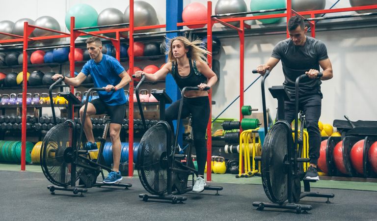 Athletes doing air bike indoor