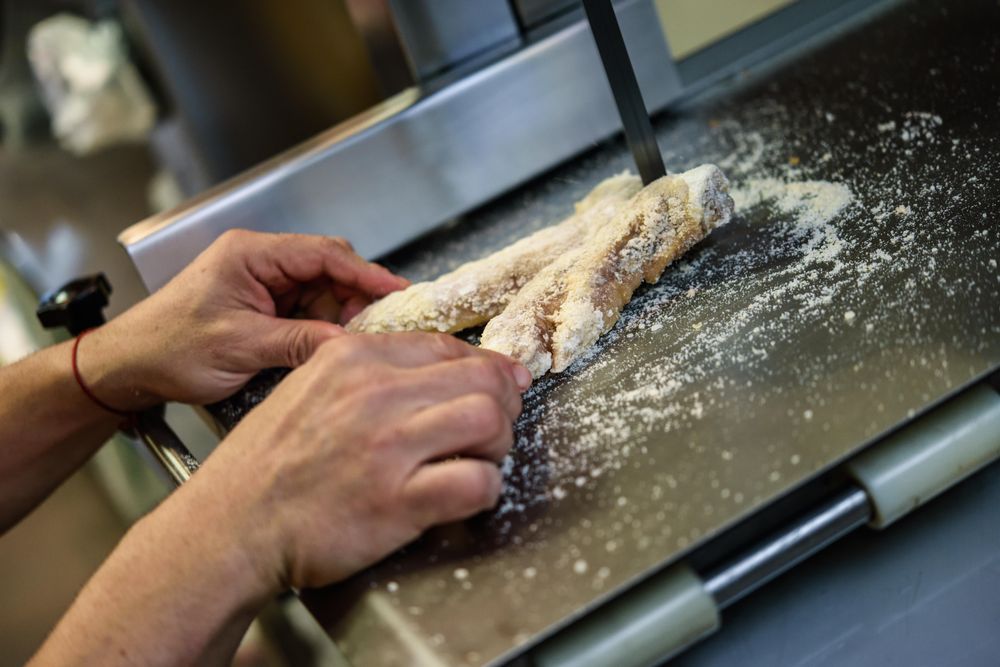Close up of man in butcher shop slicing meat