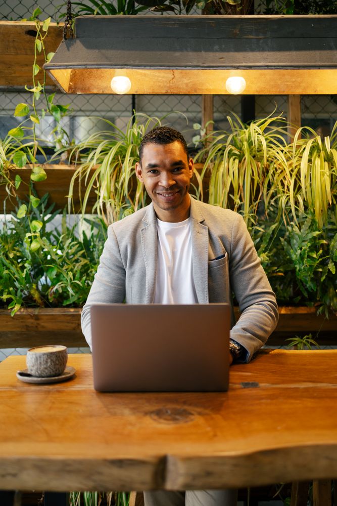 Man working on laptop at cafeteria