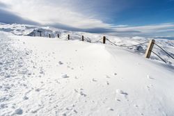 Snowy fence in ski resort of Sierra Nevada in winter