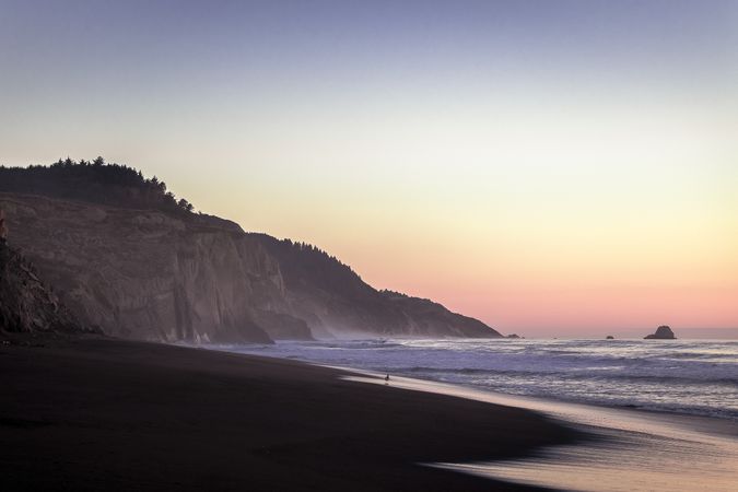 Cliffs on beach at sunset as tide goes out
