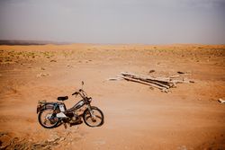 Motorbike and logs in desert