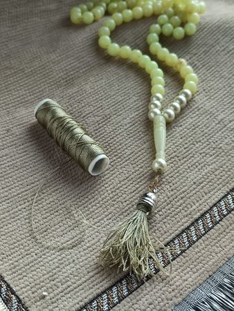 Green and pearly praying beads with green strings