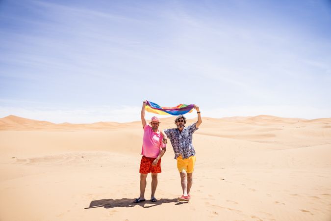 Excited gay couple in desert