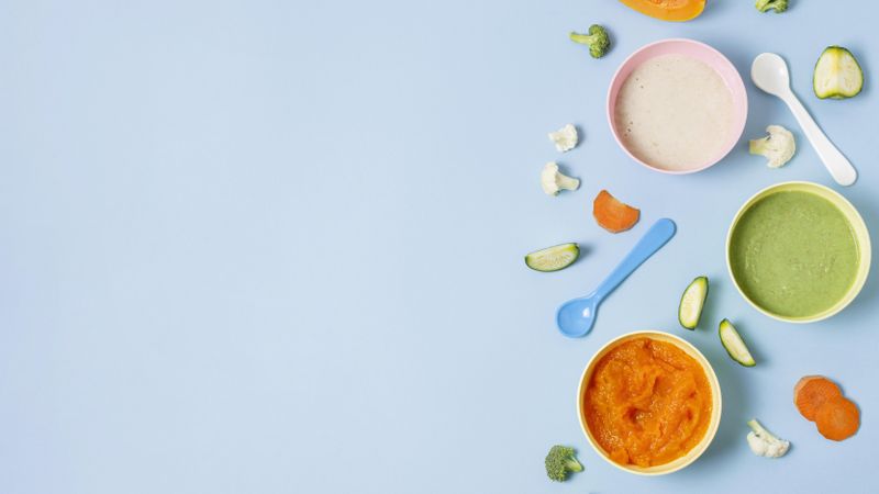 Baby food on blue background