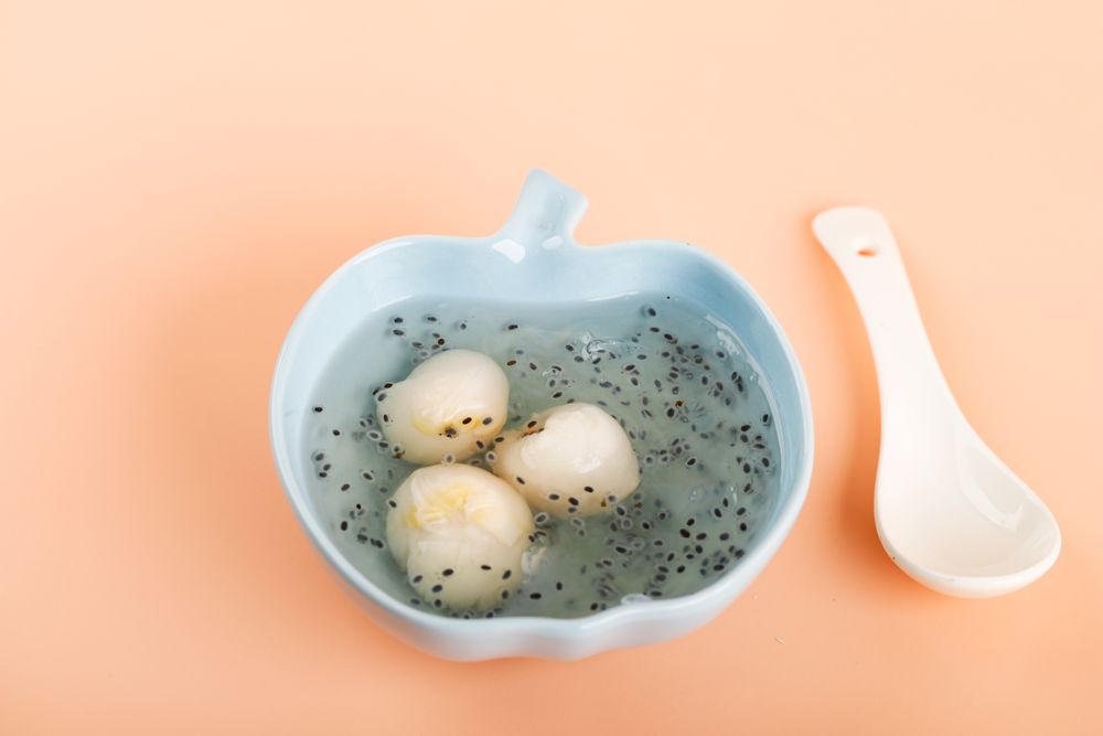 Bowl of sarang burung, canned lychee pudding with basil seed with spoon