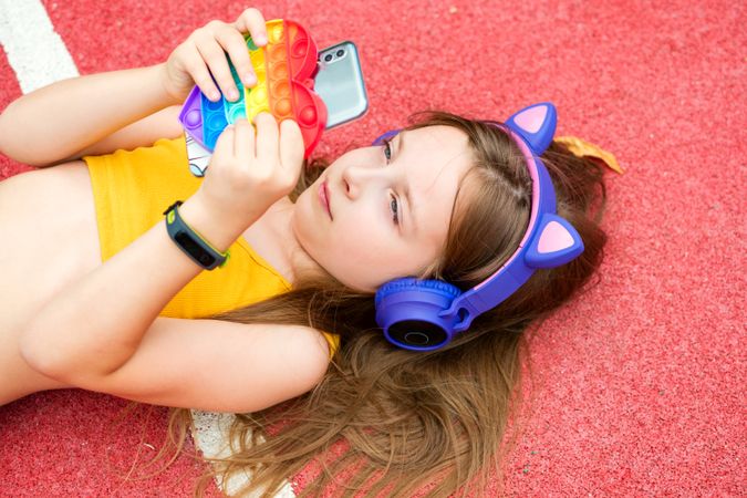 Girl with colorful toy and smartphone
