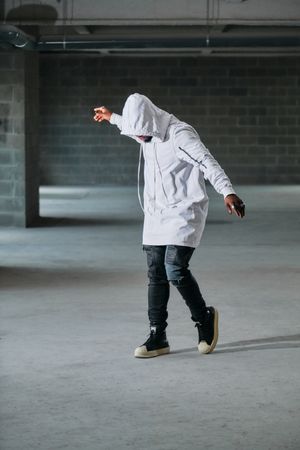 Unrecognizable man dancing in garage