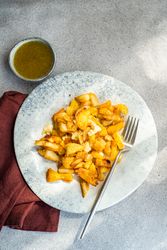 Fried potato slices with sour sauce
