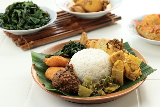 Nasi Padang or Nasi Kapau with Rendang, Sambal Ijo, and Squid Curry