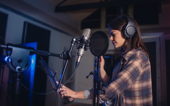 Woman recording music in a professional recording studio