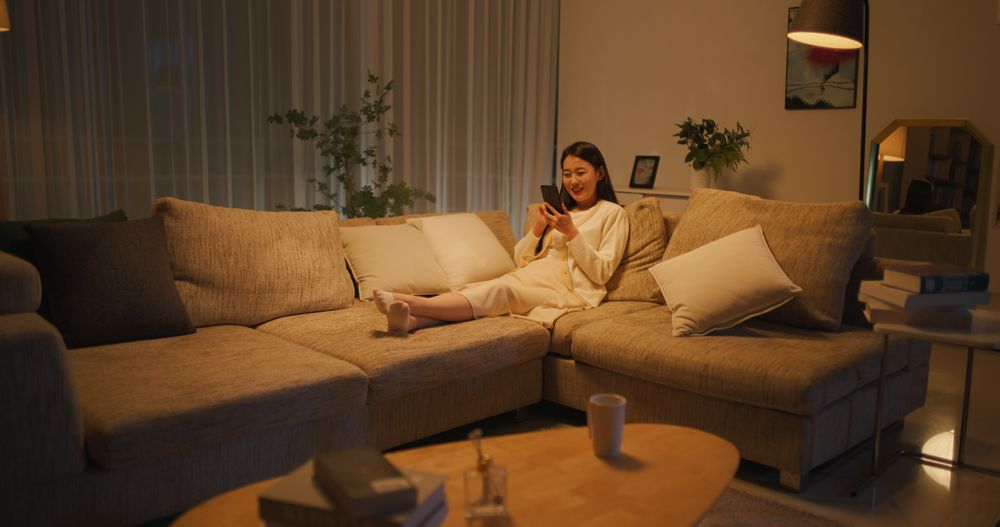 Young South Korean Woman Engaged and Connected Online, Enjoying Leisure Time with Her Smartphone