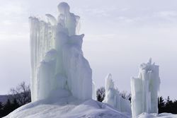 Ice structures in a snowy park with trees