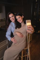 Smiling mother and daughter taking selfie