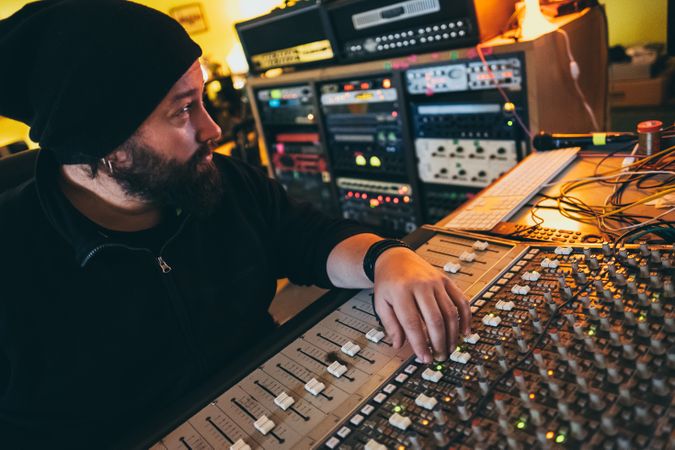 Man in a equalizer instrument in a studio