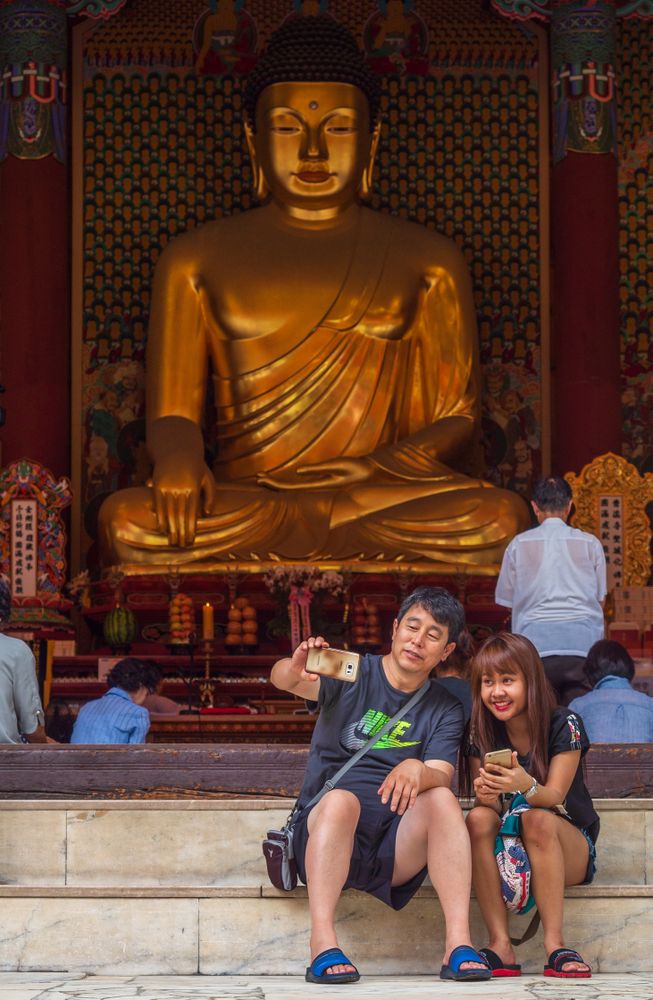 Seoul, South Korea - August, 08 2017: Asian couple taking selfie near Buddhist shrine