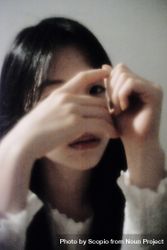 Portrait of young woman hiding her face 4MJv1b