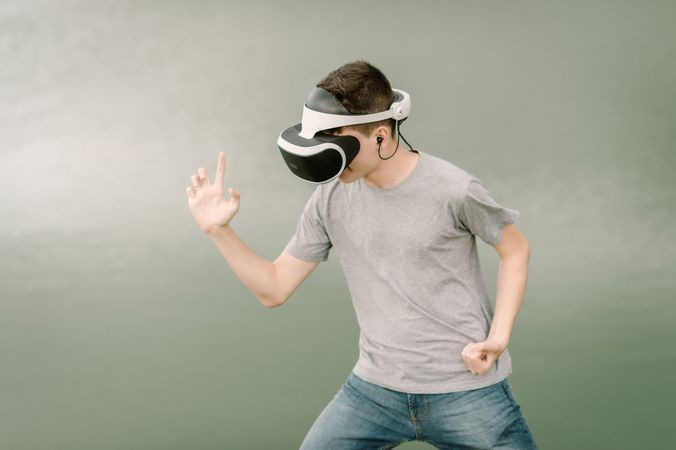 Young teenager with virtual reality glasses outdoors