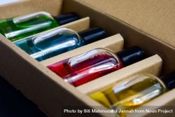 Four colorful perfume bottles in a box 0WOPg1