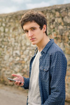 Hipster man using a smart phone outdoors