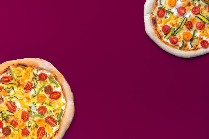 Homemade vegetarian pizza isolated on a magenta colored background