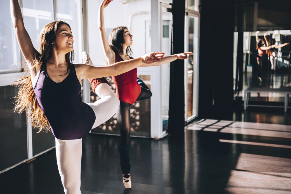 Young ballerinas dancing expressively