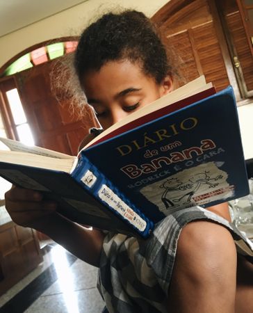 Girl reading a book indoor