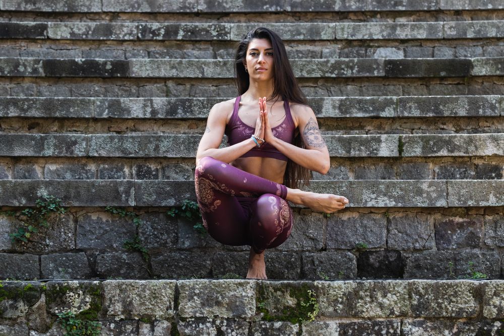 Woman practicing yoga in Toe Stand pose