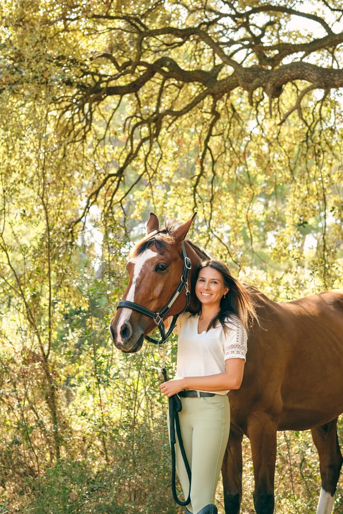 Charming horsewoman embracing horse in forest