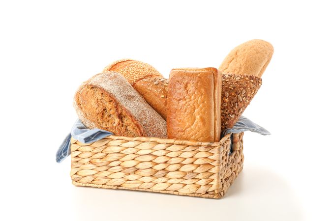 Bakery products in straw basket isolated on blank background