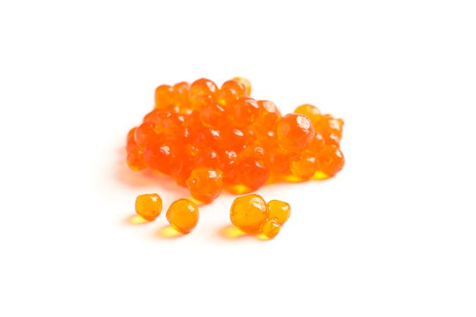 Red caviar isolated on blank background, closeup