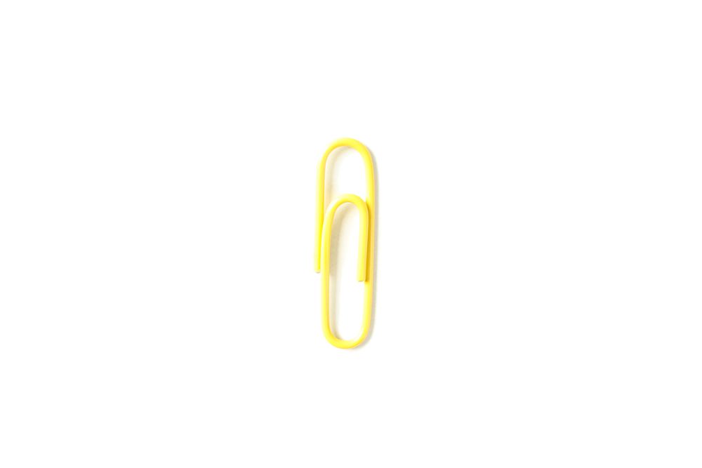 Color paper clip isolated on plain background, closeup
