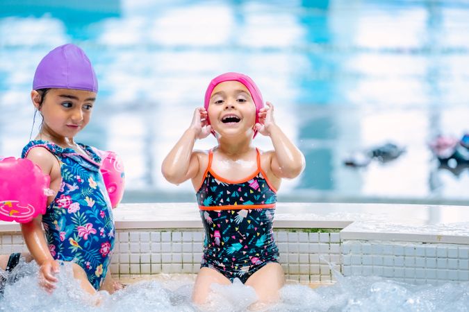girls with water wings in swimming pool