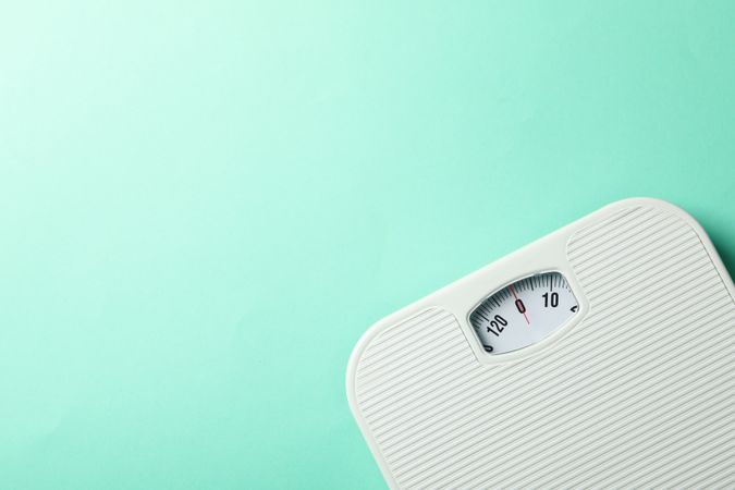 weight scales on mint background. Weight loss concept
