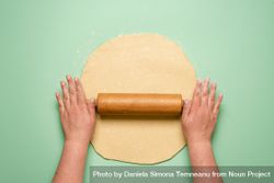 Rolling out pie dough on mint background 5w9WRb