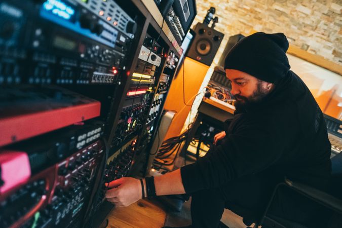 Man adjusting sound control in a studio