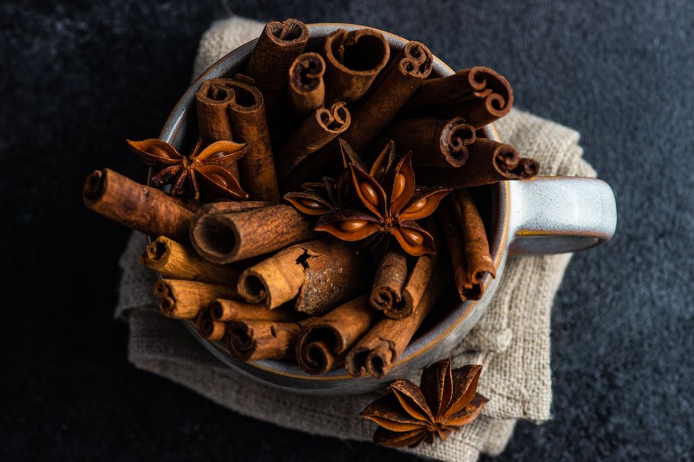 Top view of cinnamon sticks and anise star in mug