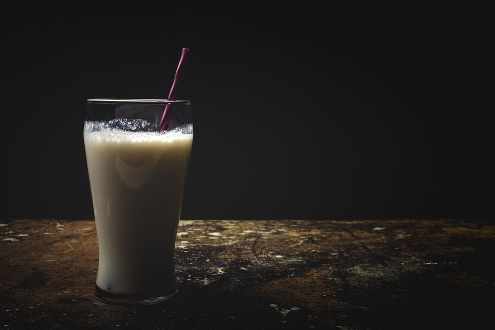 Glass of milk on table