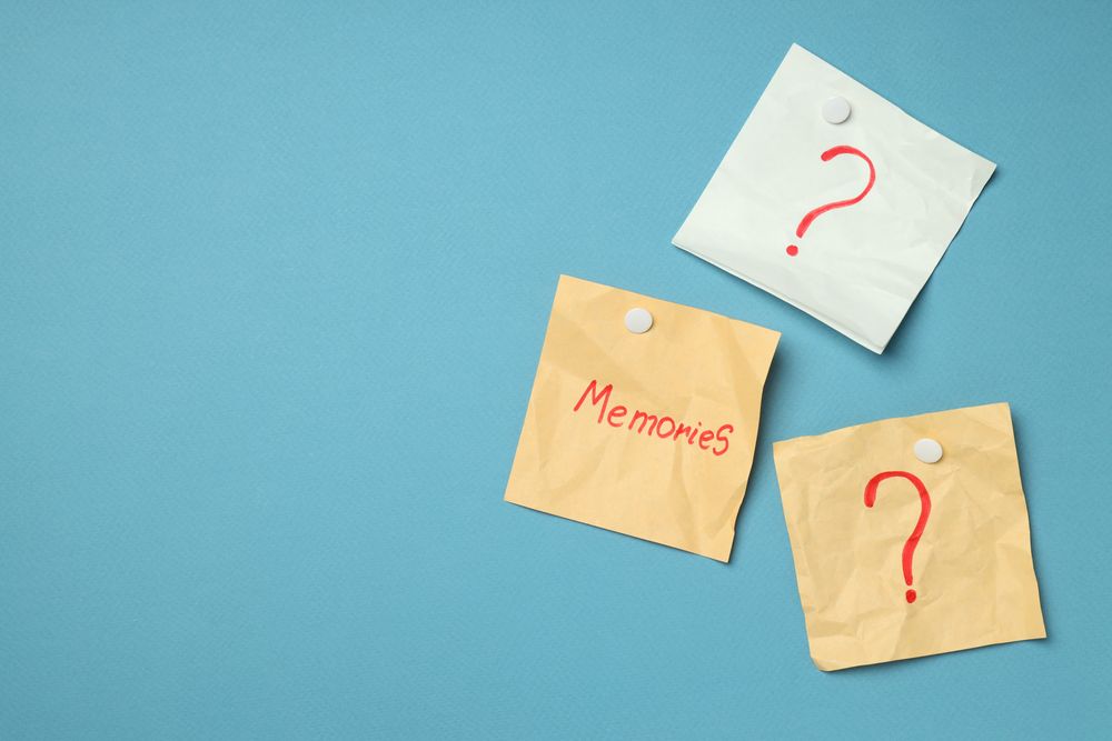 Pinned post it notes with the word “memories” on blue board, copy space