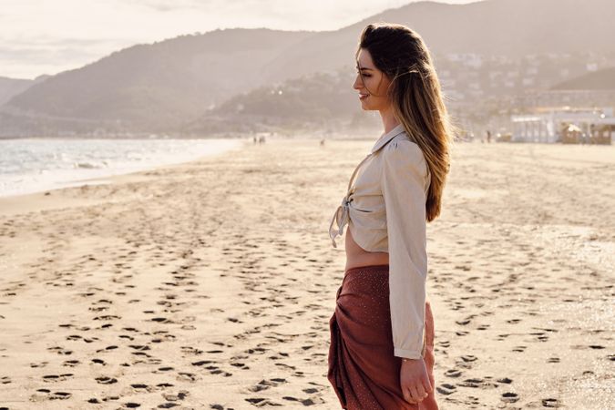 A fashion model at the beach before sunset