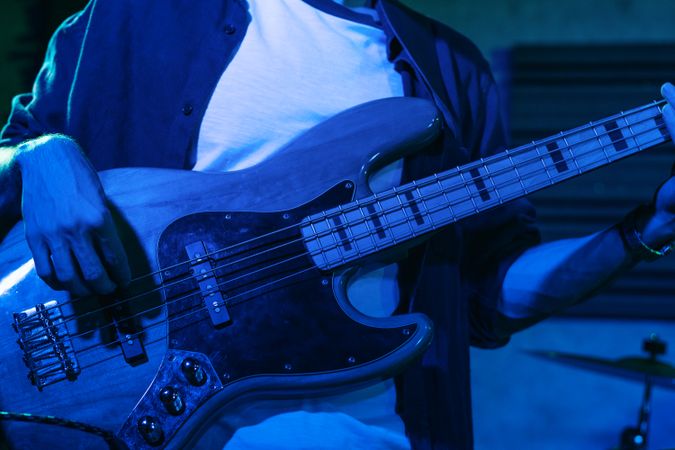 Bass Player Performing In A Live Concert